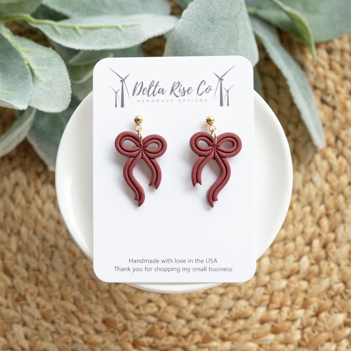 Handmade maroon bow earrings, perfect for fall and autumn fashion. Lightweight polymer clay earrings in a rich seasonal maroon color, ideal for Thanksgiving, cozy fall outfits, or gifting to friends and family. Simple yet elegant bow design adds a chic seasonal touch to everyday wear, making these handmade earrings a versatile autumn accessory for seasonal style and festive outfits.