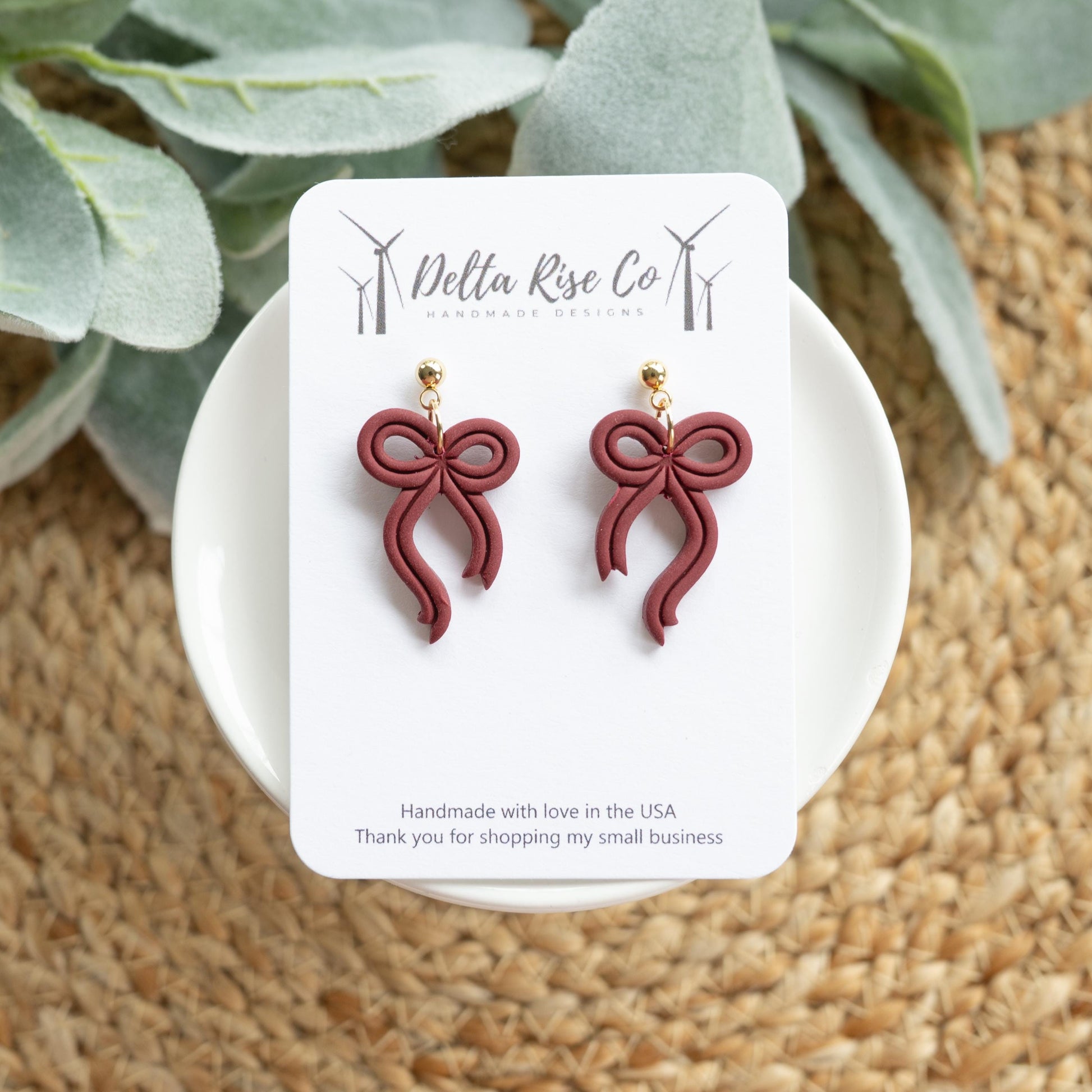 Handmade maroon bow earrings, perfect for fall and autumn fashion. Lightweight polymer clay earrings in a rich seasonal maroon color, ideal for Thanksgiving, cozy fall outfits, or gifting to friends and family. Simple yet elegant bow design adds a chic seasonal touch to everyday wear, making these handmade earrings a versatile autumn accessory for seasonal style and festive outfits.