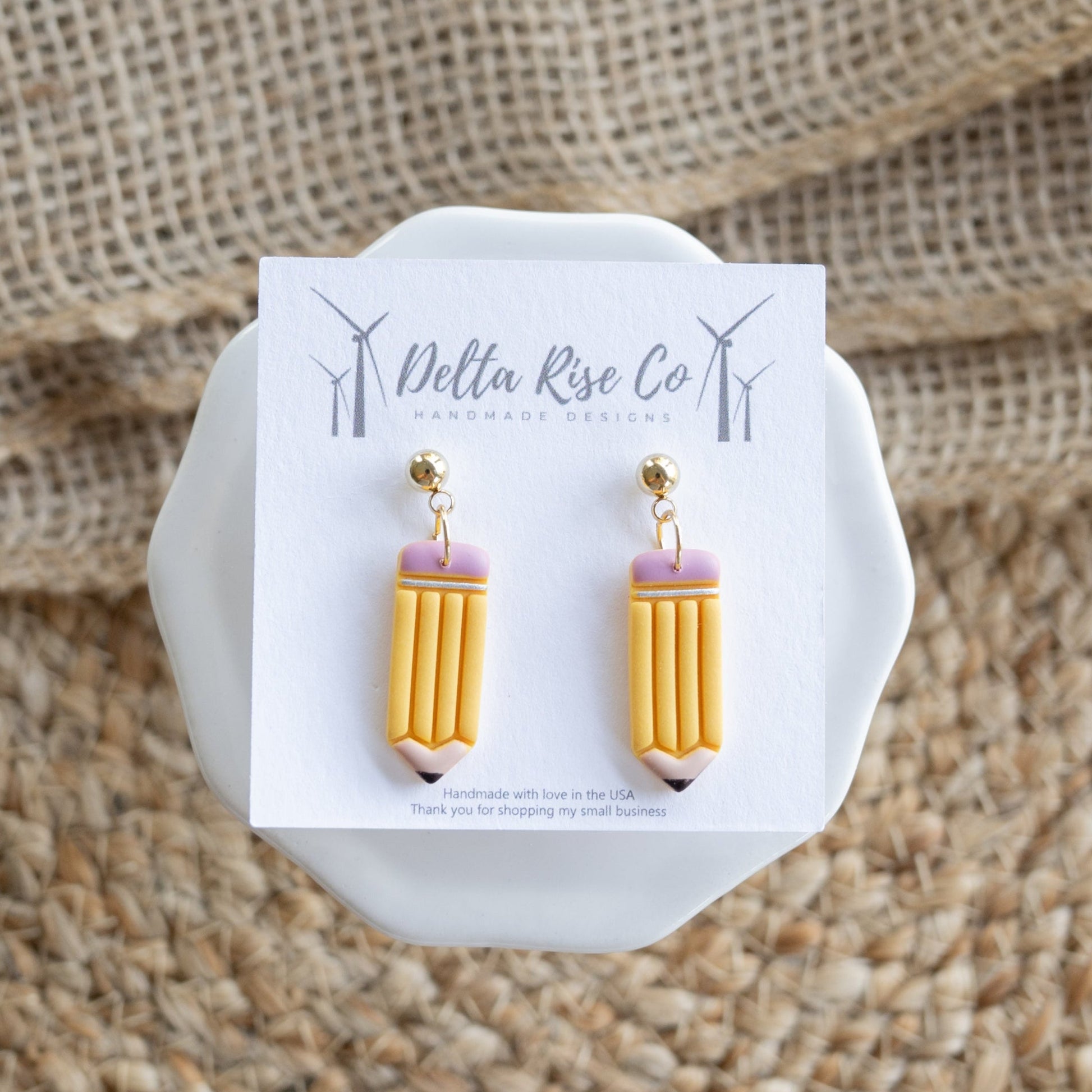 Handmade clay dangle earring shaped like a pencil.